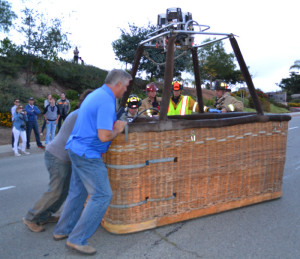 Pilot Phil Brandt was assisted by San Diego firefighters in moving the hot air balloon's basket from the road.