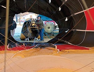 Ken Tadolini, lights the fire of his hot air balloon, 'Outlaw,' on April 17 before a practice flight above Cañon City.